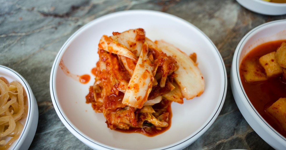 An overhead spread of bowls of kimchi and other fermented vegetables