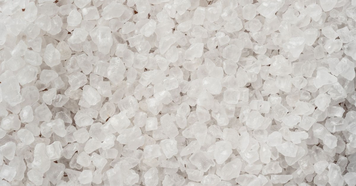 A close-up, full-frame view of coarse white sea salt crystals filling the entire frame