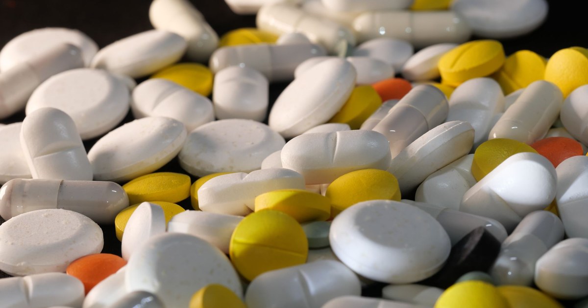 A large pile of assorted vitamin pills and capsules