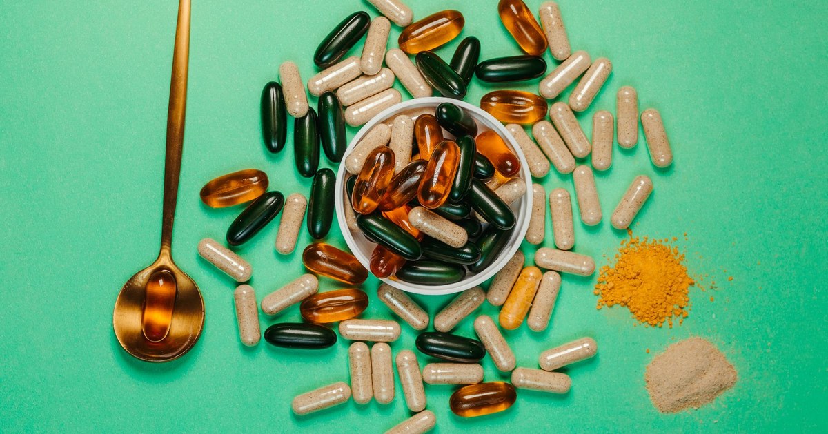 An assortment of supplement capsules, softgels, and powder