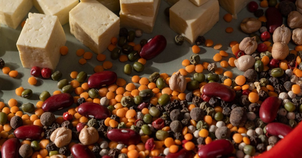 A spread of plant-based protein foods including tofu, beans, and lentils